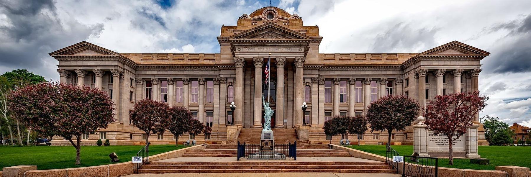 Court house with small statue of liberty in front